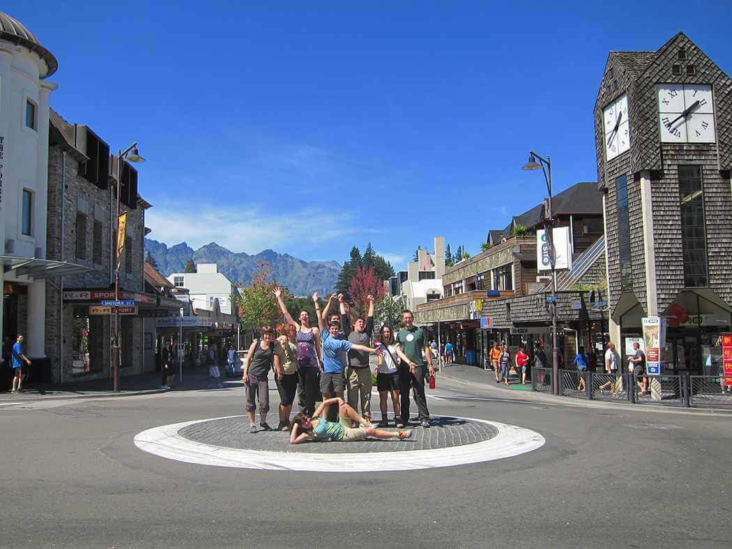 A group posing for a photo in a town center