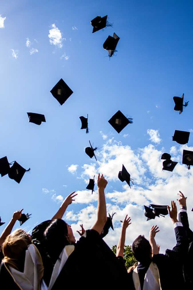 graduation hats tossed in the air