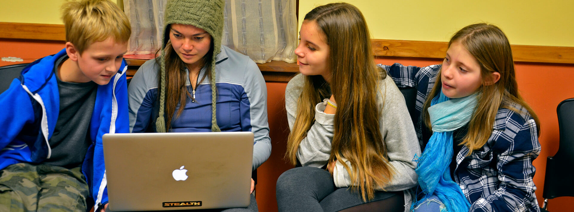 young people looking at a laptop computer