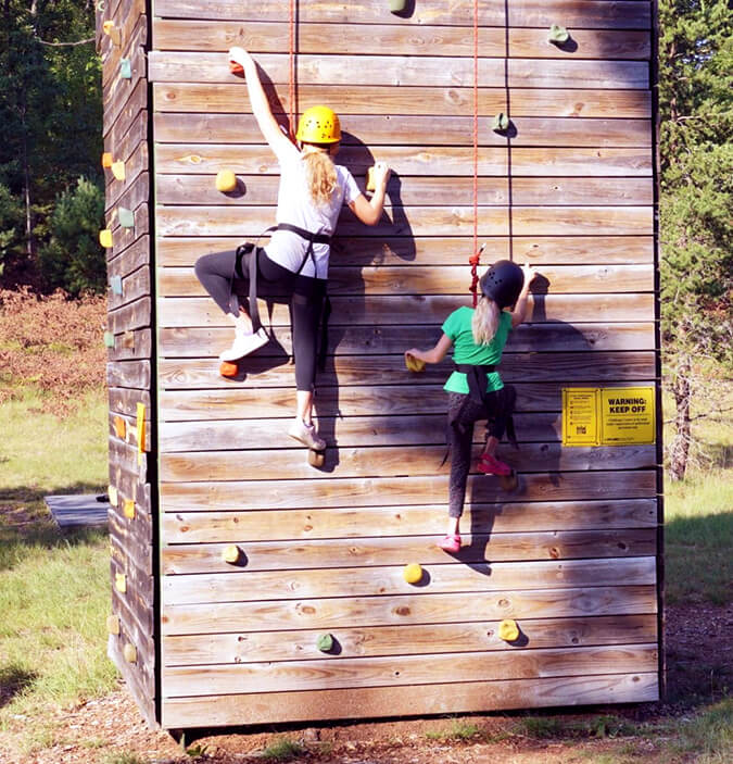 children climbing a wall