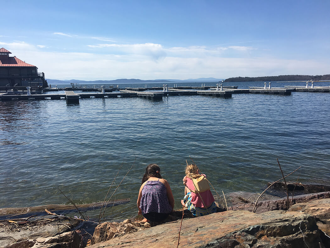 children kneeling near water