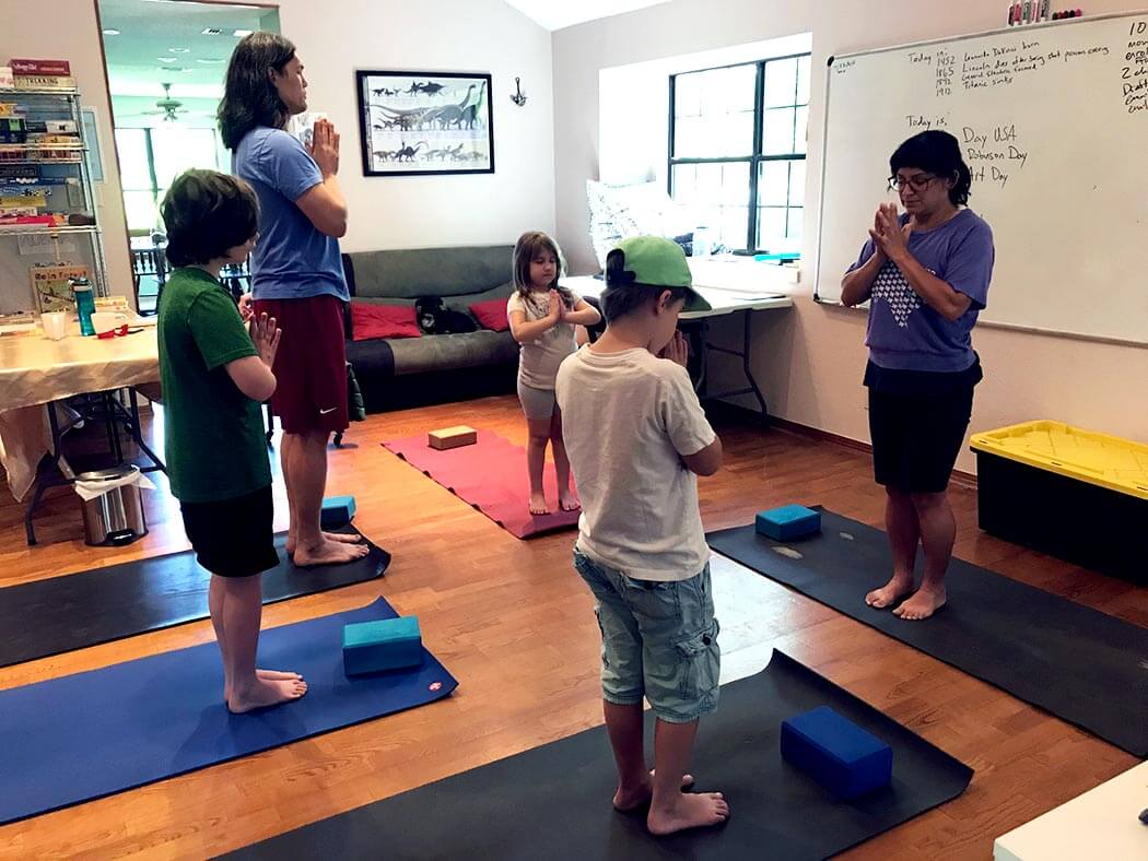 children and adults in a yoga class