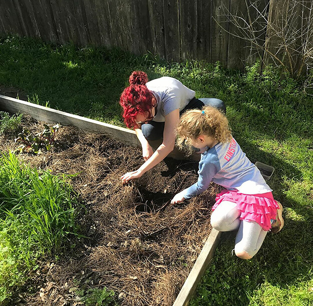 An adult and child gardening